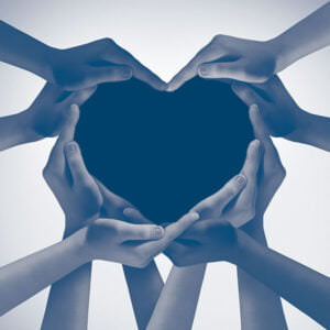 Heart hands as a group of diverse people hands connected together shaped as a love symbol expressing the feeling of being happy and togetherness.