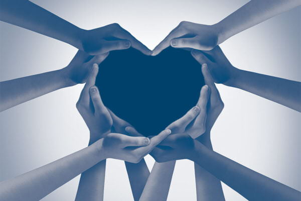 Heart hands as a group of diverse people hands connected together shaped as a love symbol expressing the feeling of being happy and togetherness.