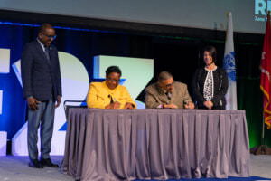 Carolyn Hardin, Chief of Training and Research at All Rise, left center, signs a memorandum of understanding between All Rise and the National Treatment Court Alumni Association with NTCAA Chair Carlos Gonzales, right center, as Terrence Walton, All Rise COO, left, and Abby Frutchey, NTCAA vice chair and All Rise board member, right, look on at RISE23 in June 2023 in Houston, Texas.
